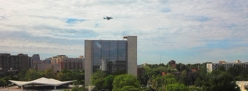 Space Shuttle Discovery flies near the Lister Hill Center, foreground.